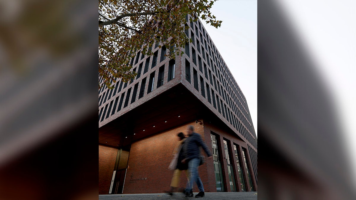 People walk past the center for advanced education (ZNAF) at the Federal Intelligence Service (BND) in Berlin Tuesday. (AP Photo/Michael Sohn)