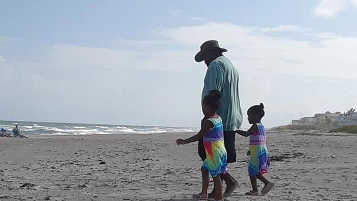 Stephone Ritchie Sr. plays with his children on Cocoa Beach before attempting to rescue his sons from a dangerous rip current.