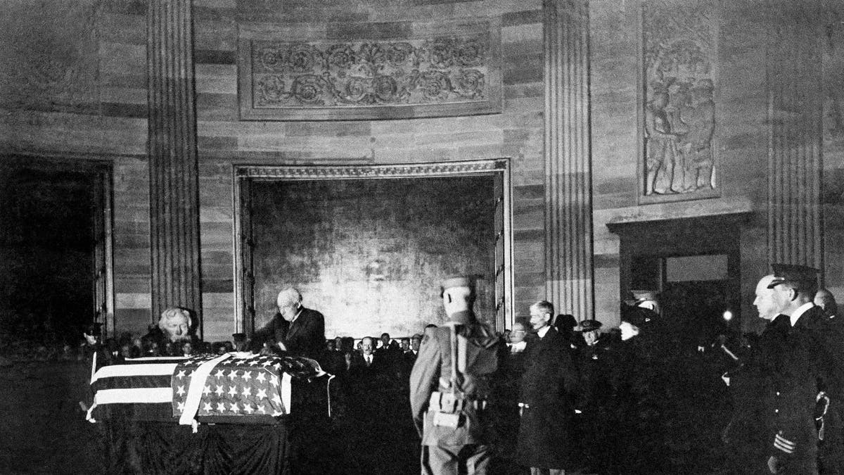 President Warren G. Harding places a wreath on the casket of an unknown soldier from World War I in the rotunda of the U.S. Capitol, Nov. 11, 1921 in Washington. (AP Photo)