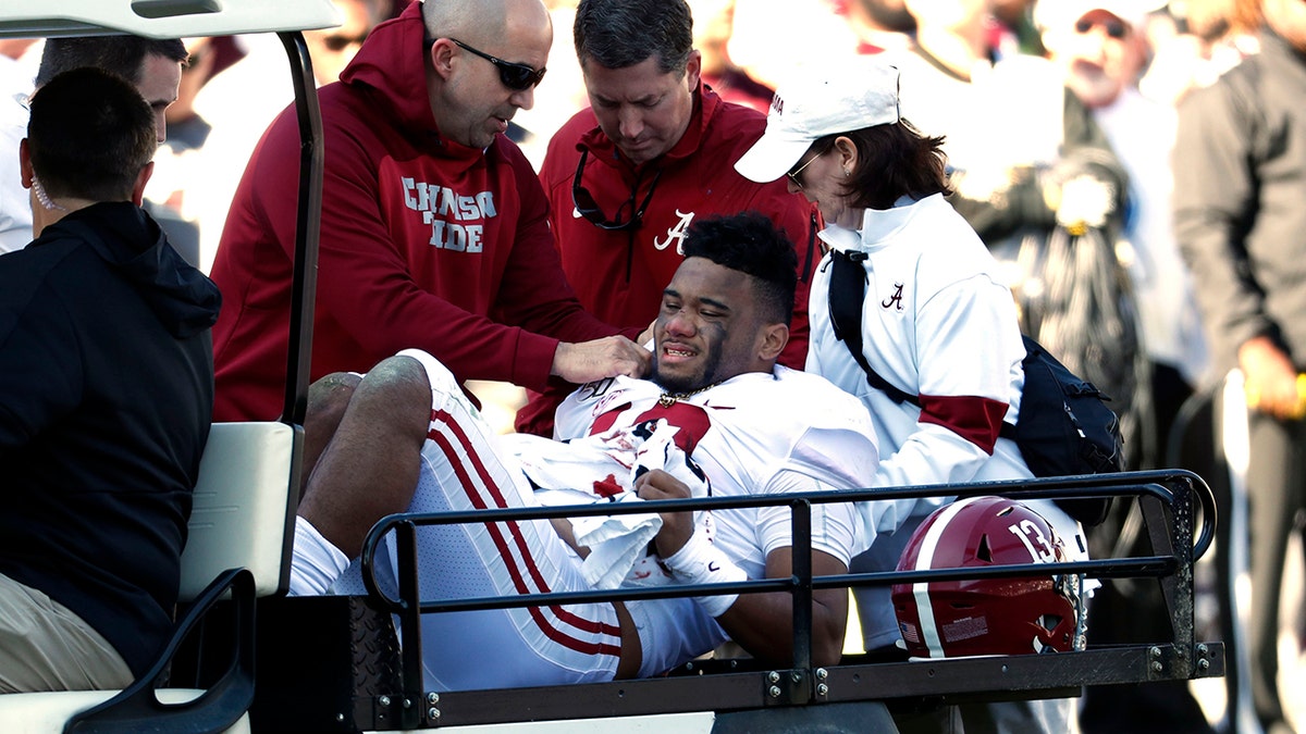Alabama quarterback Tua Tagovailoa (13) is carted off the field after getting injured in the first half of an NCAA college football game against Mississippi State in Starkville, Miss., Saturday, Nov. 16, 2019. (AP Photo/Rogelio V. Solis)
