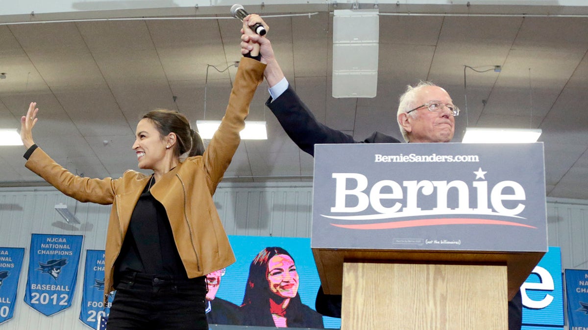 Democratic presidential candidate Sen. Bernie Sanders, I-Vt., and Rep. Alexandria Ocasio-Cortez, D-N.Y., stand on stage on the campus of Iowa Western Community College in Council Bluffs, Iowa, Friday, Nov. 8, 2019. (AP Photo/Nati Harnik)
