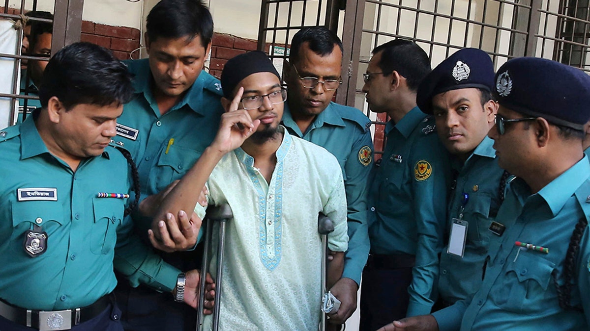 Police escort a member of a banned militant group after he was sentenced to death for an attack on a cafe that killed more than 20 people in Dhaka, Bangladesh, in 2016. (AP)