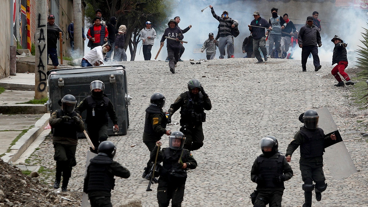 Supporters of former President Evo Morales clash with police in La Paz on Monday. (AP Photo/Juan Karita)