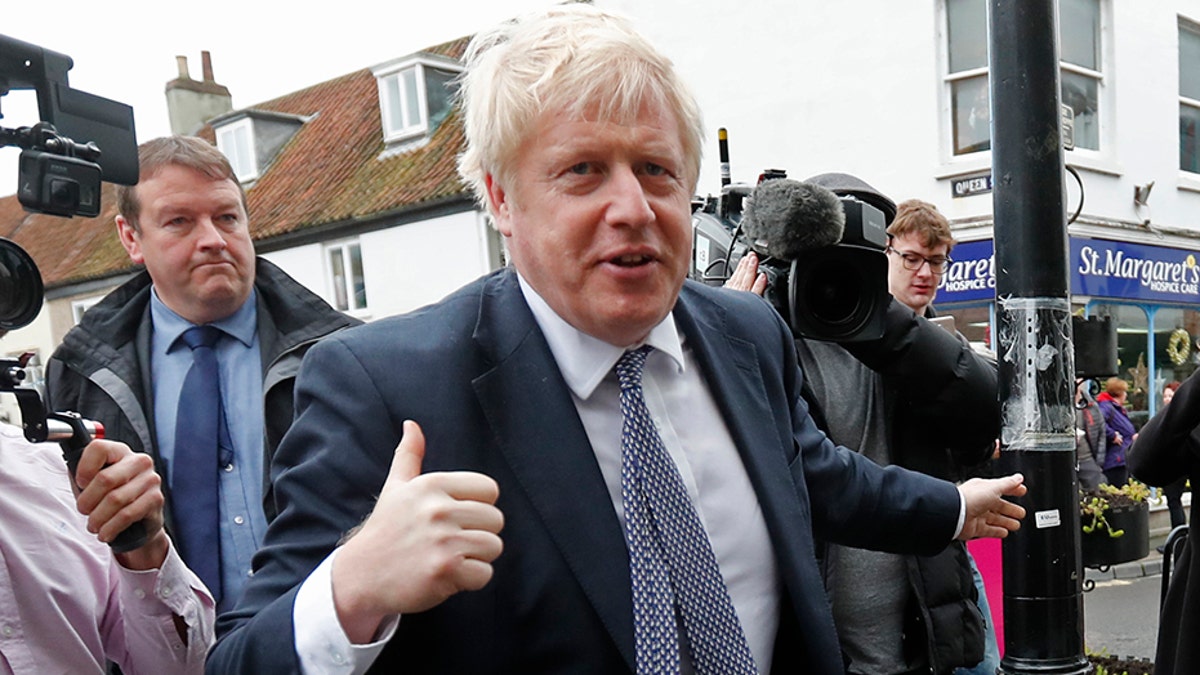 Britain's Prime Minister Boris Johnson has his picture taken during a General Election campaign stop in Wells, England, on Thursday. (AP)