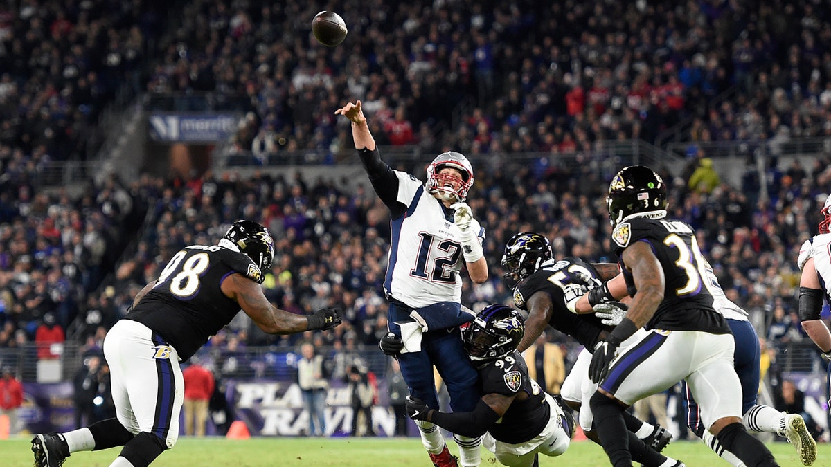 New England Patriots quarterback Tom Brady (12) attempts a pass as Baltimore Ravens linebacker Matthew Judon (99) makes a hit during the first half of an NFL football game, Sunday, Nov. 3, 2019, in Baltimore. The pass was incomplete. 