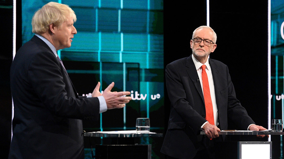 In this photo issued by ITV, Jeremy Corbyn, right, and Boris Johnson, during the election head-to-head debate live on TV, in Salford, Manchester, England, on Tuesday. (AP/ITV)
