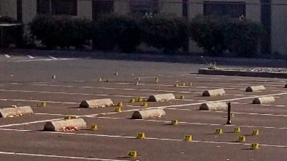 Crime scene evidence markers were placed in the parking lot of the Searles Elementary School where two boys were fatally shot early Saturday morning. (Union City Police Department via AP)