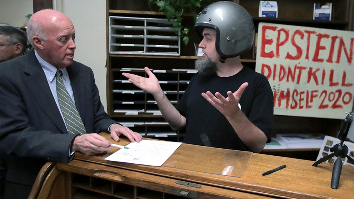 A candidate who called himself Rod Epstein Didn't Kill Himself Webber attempts to file to be listed on the New Hampshire primary ballot on Friday, in Concord, N.H. New Hampshire Secretary of State Bill Gardner, left, did not accept the application since he did not file using his legal name.