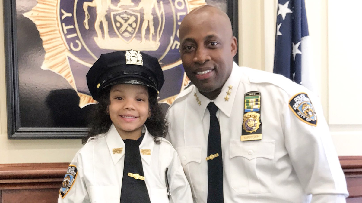 Ferni Balbuena at the 52nd precinct with Chief of Patrol Rodney Harrison