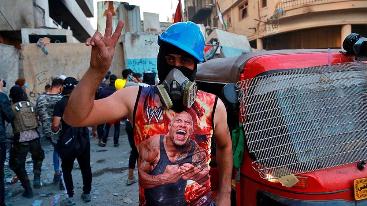 An anti-government protester flashing a victory sign in Baghdad on Sunday.