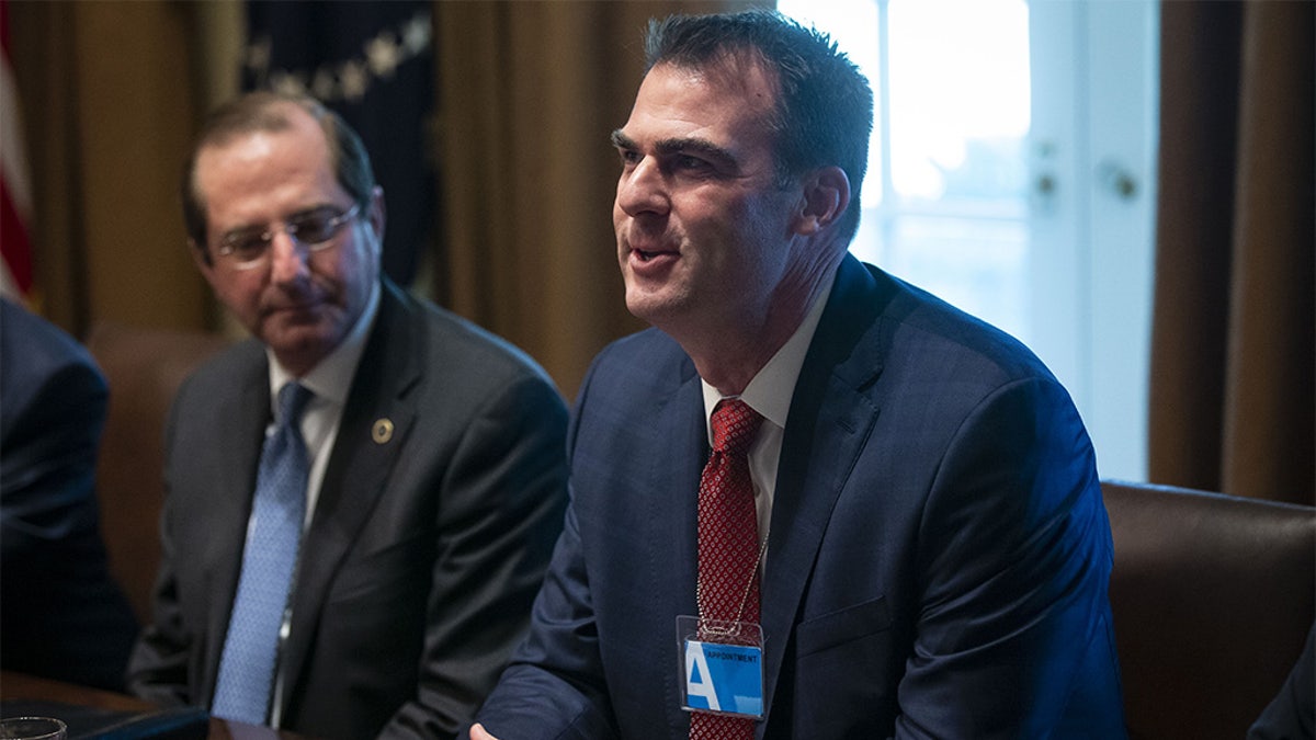 Kevin Stitt, then governor-elect of Oklahoma, right, speaks during a meeting with U.S. President Donald Trump in the Cabinet Room of the White House in Washington, D.C., U.S., on Thursday, Dec. 13, 2018. The state plans to release more than 400 inmates Monday in the largest one-day commutation ever. (Photographer: Al Drago/Bloomberg via Getty Images)