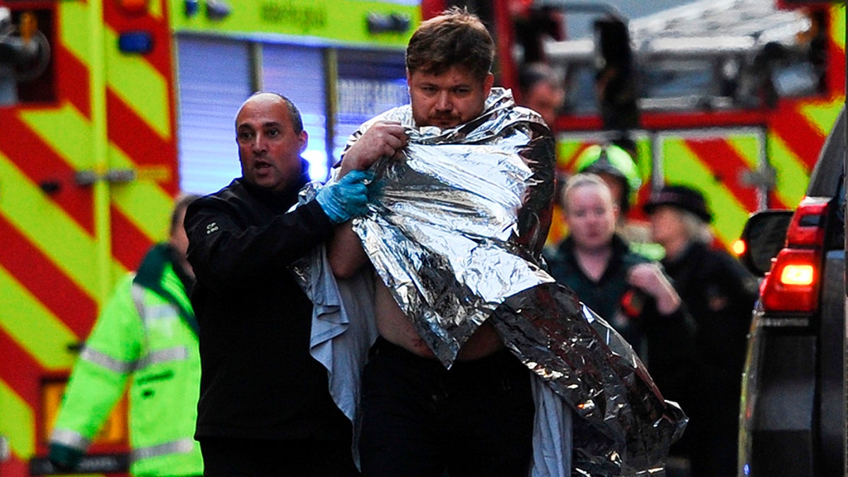 Police assisted an injured man near London Bridge after reports of shots being fired. (Photo by DANIEL SORABJI/AFP via Getty Images)