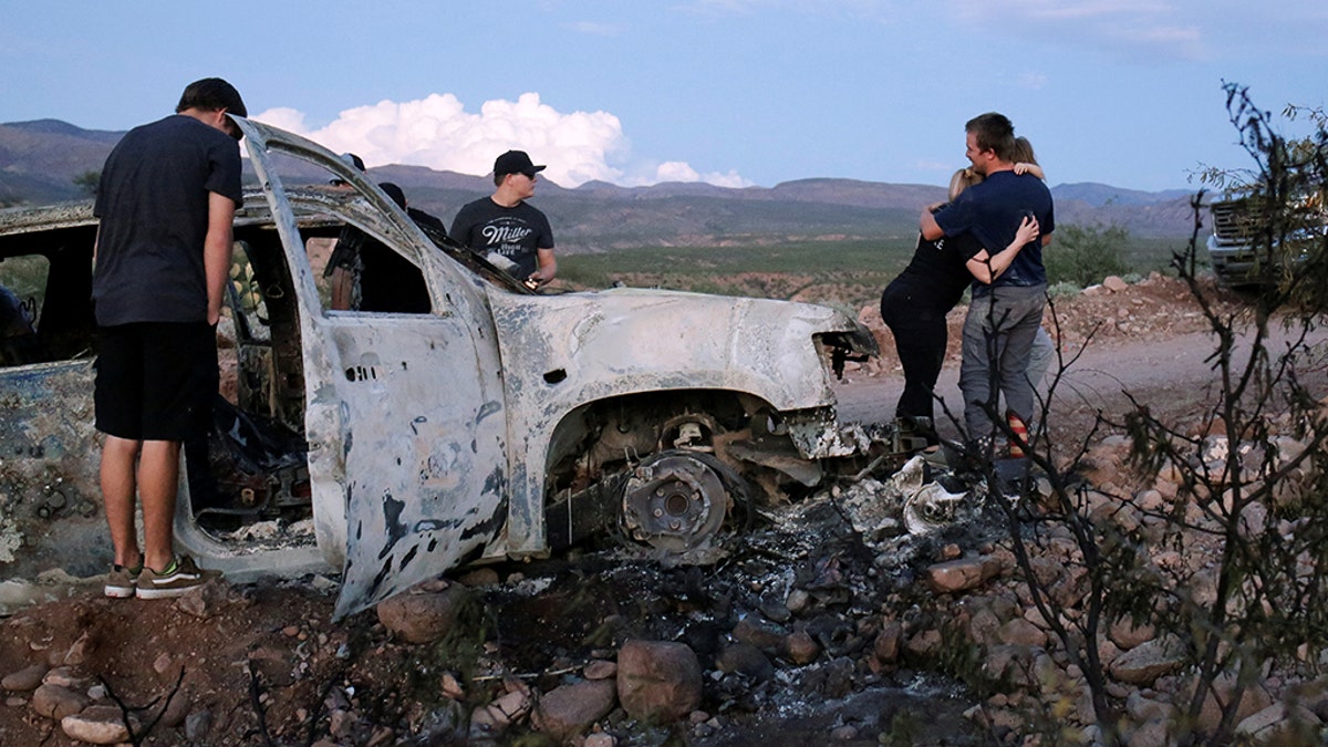 Relatives of slain members of Mexican-American families belonging to Mormon communities observe the burnt wreckage of a vehicle where some of their relatives died, in Bavispe, Sonora state, Mexico in November. A police chief has been arrested for suspected links to the killings, authorities said this week. REUTERS/Jose Luis Gonzalez 