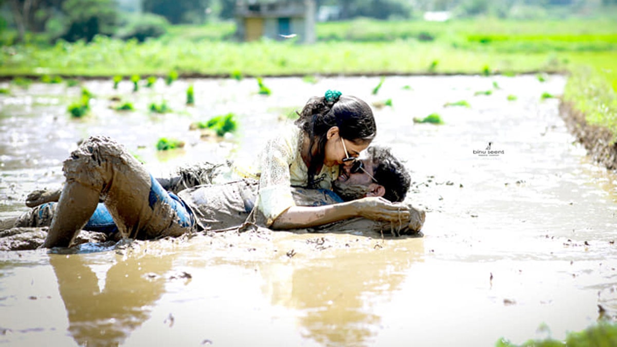 The series of photos showed the couple smiling and cuddling while laying down in a muddy pool of water in a grassy countryside.