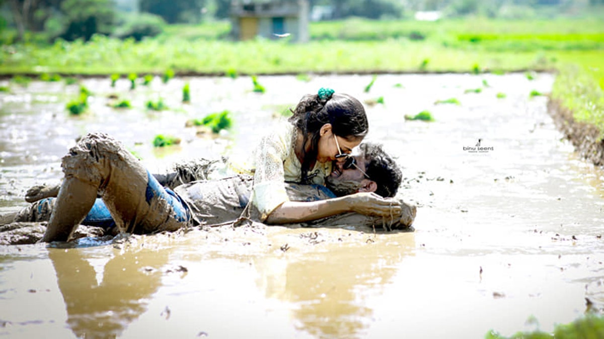 The series of photos showed the couple smiling and cuddling while laying down in a muddy pool of water in a grassy countryside.