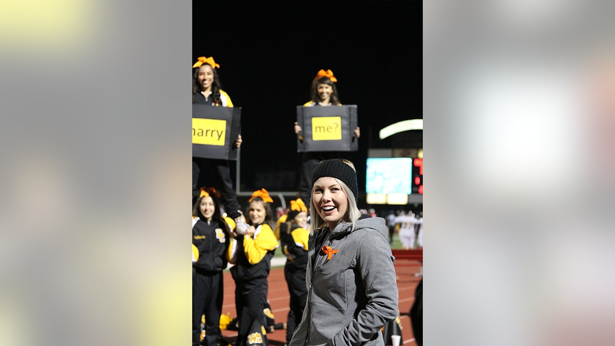Natalie Earthman, an English teacher and cheerleading coach at East Central High School, admitted that she was somewhat bummed that her squad had to cheer at a football game on Halloween. The ECHS alumnus, however, had no idea that she was in for a life-changing surprise.