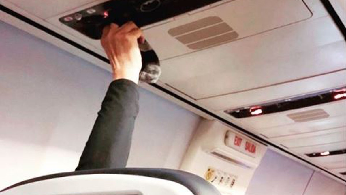 “Drying sweaty socks using the air vent,” text over the image of the passenger holding the socks read on Instagram.