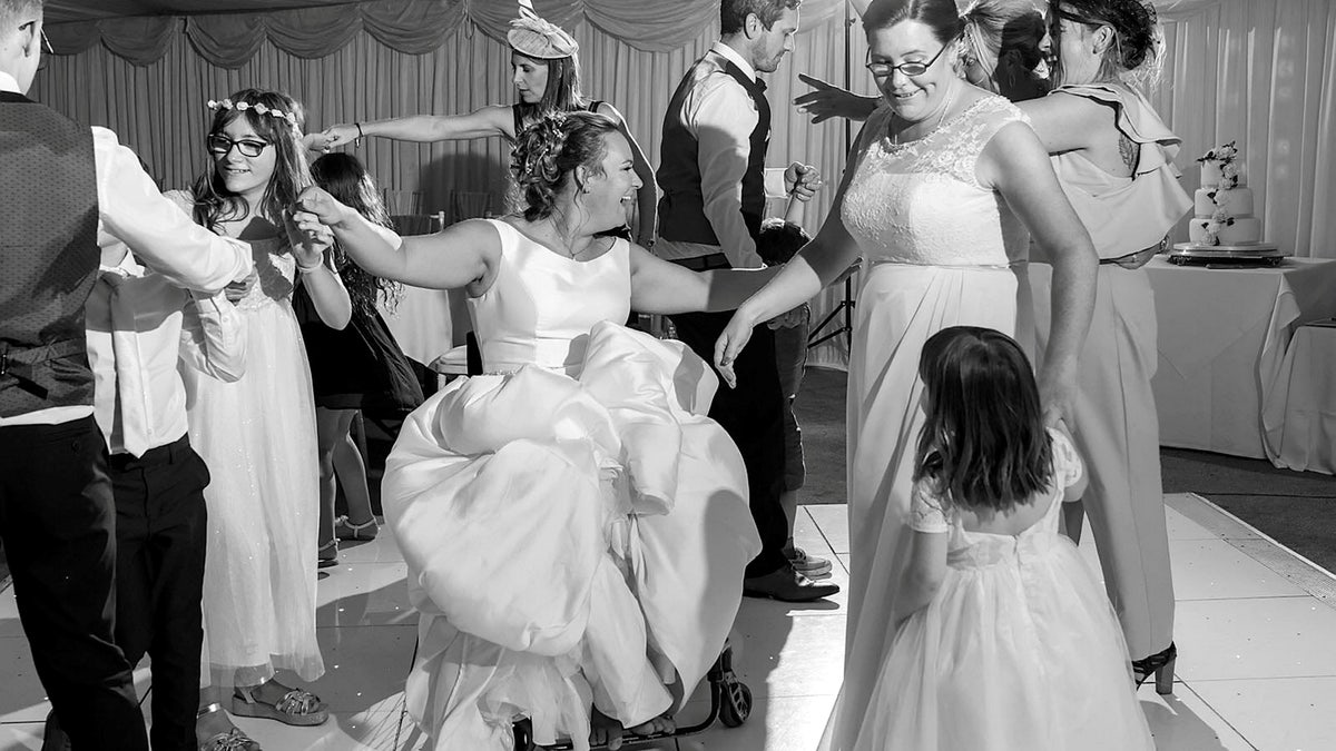 Emma Kitson dancing on her wedding day in her wheelchair.