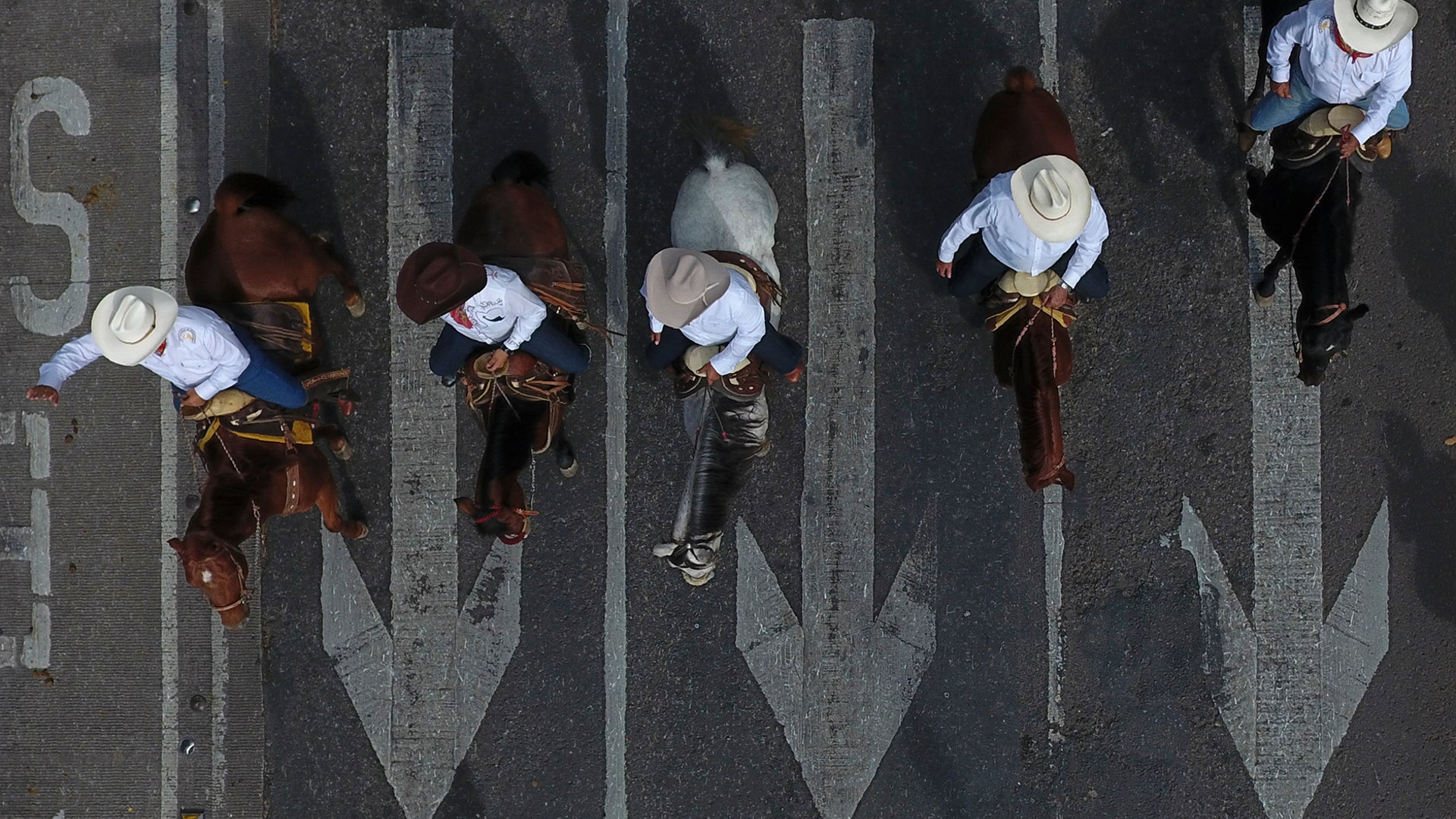 Men ride horses down Paseo de la Reforma during a parade marking the 109th anniversary of the start of the Mexican Revolution, in Mexico City, Nov. 20, 2019. 