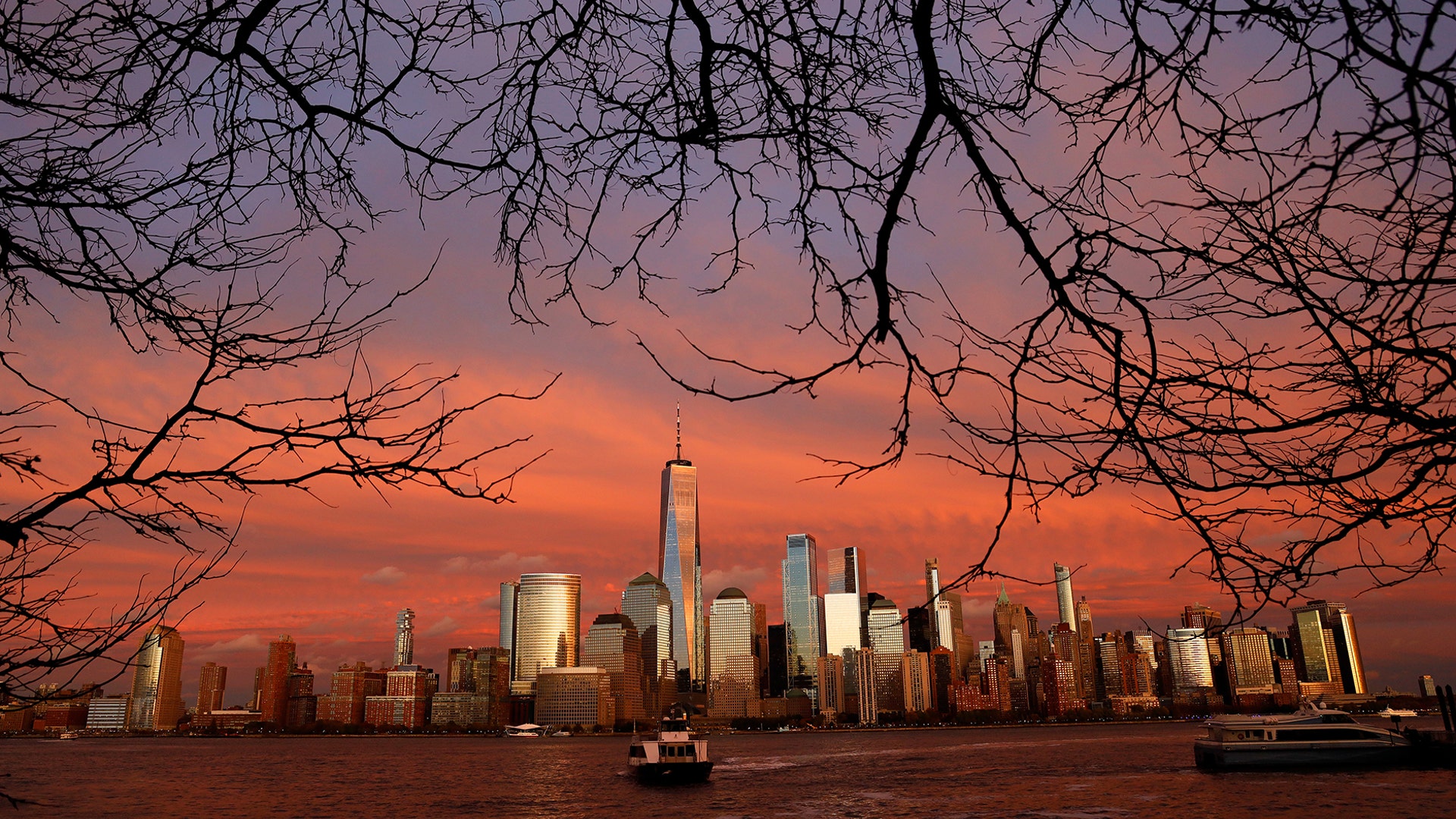 The sun sets on lower Manhattan and One World Trade Center in New York City, Nov. 12, 2019. (Photo by Gary Hershorn/Getty Images)