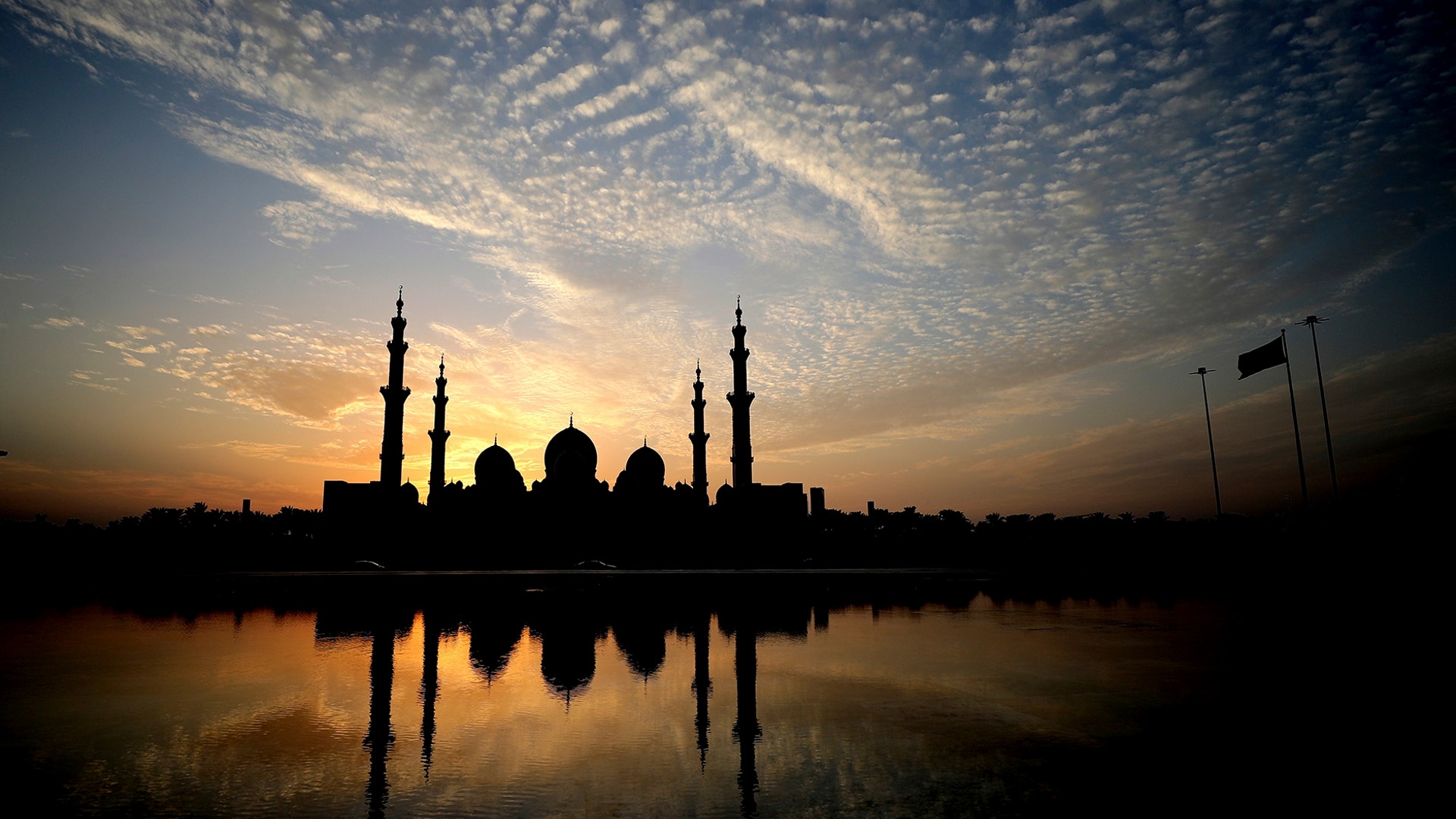The sun sets behind the Sheikh Zayed Grand Mosque in Abu Dhabi, United Arab Emirates, Nov. 8, 2019.