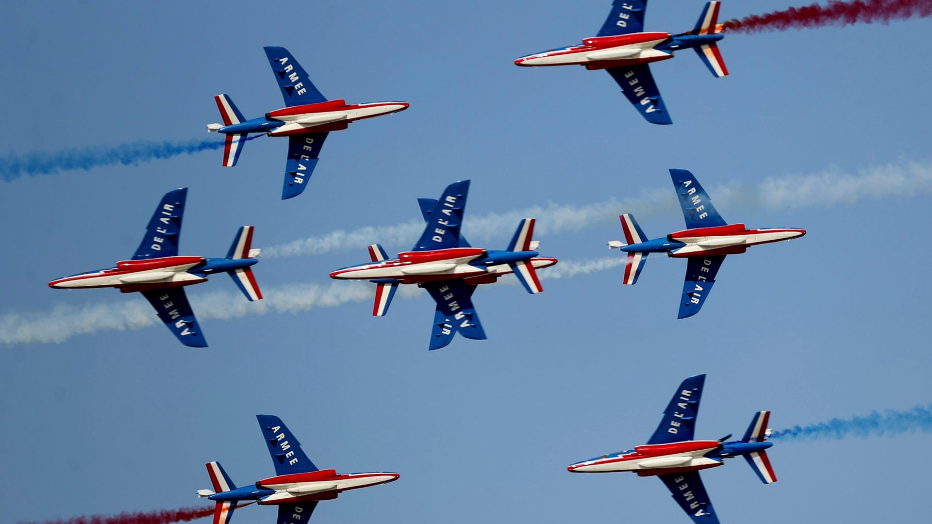 The Patrouille de France air team spray colored smoke during a performance at the Dubai Airshow in Dubai, United Arab Emirates, Nov. 17, 2019. 