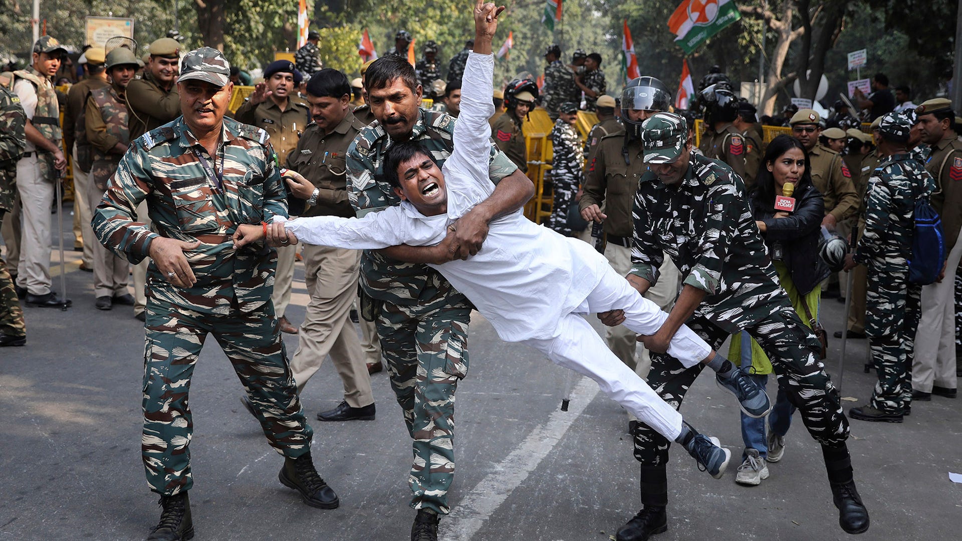 Indian paramilitary soldiers detain a Congress party supporter during a protest against the proposed withdrawal of the Special Protection Group providing security for president Sonia Gandhi, her children Rahul Gandhi and Priyanka Vadra and former prime minister Manmohan Singh, in New Delhi, India, Nov. 20, 2019. 
