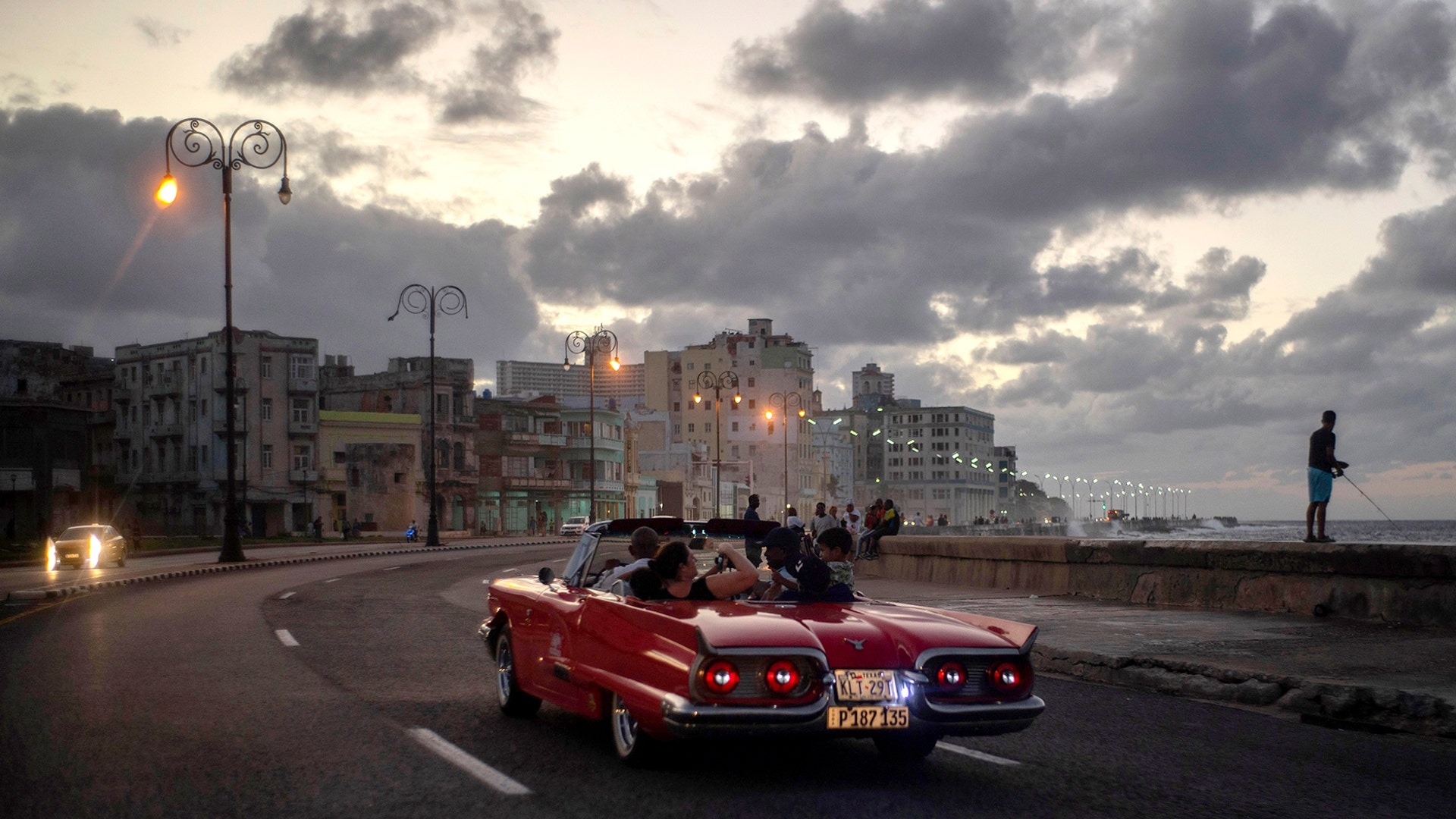 Tourists take a joy ride along the Malecon sea wall in Havana, Cuba, Nov. 10, 2019.