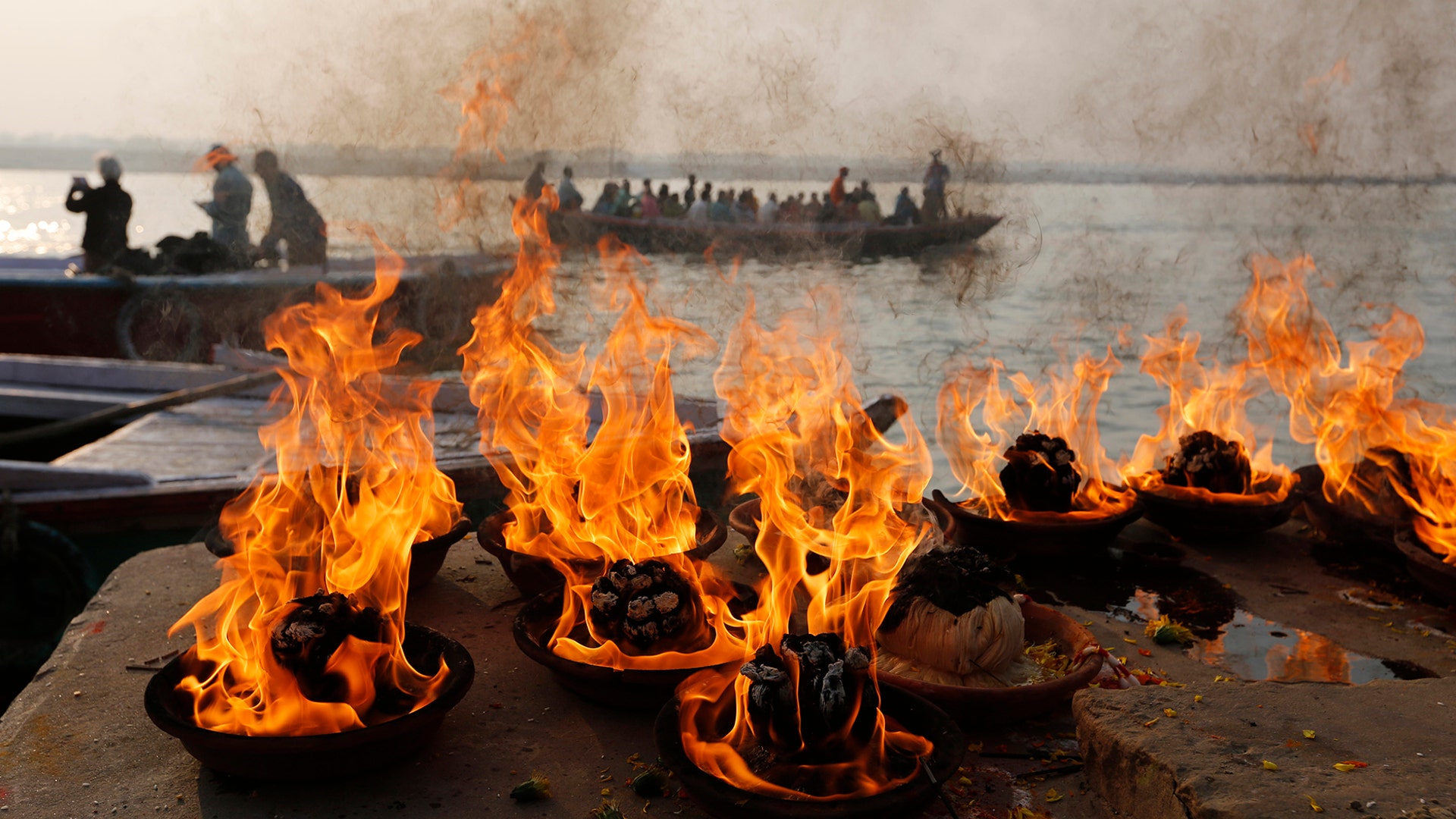 Hindus make fires on the banks of the River Ganges as part of rituals during Karthik Purnima festival in Varanasi, India, Nov. 12, 2019.