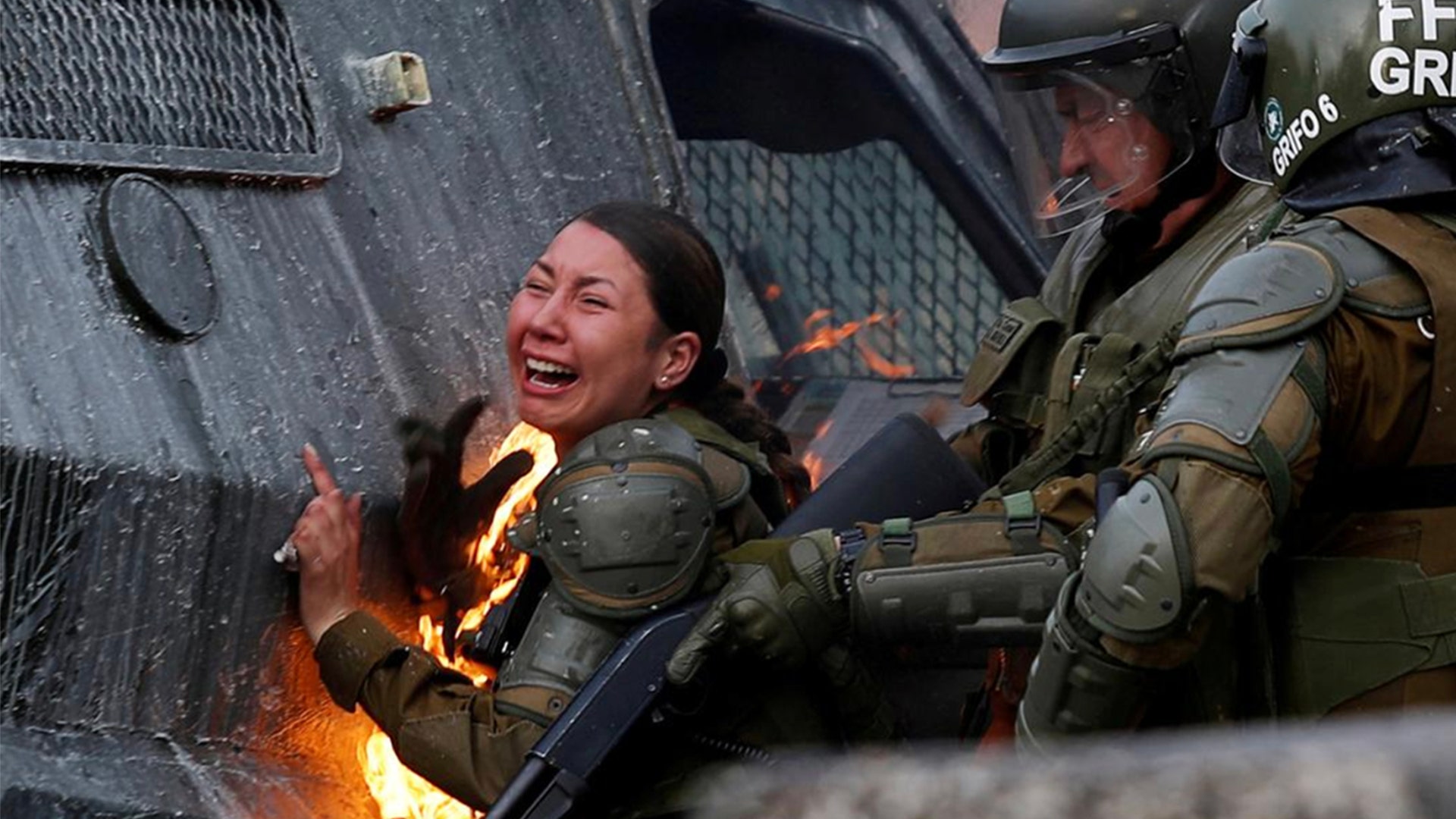 A riot police officer on fire reacts during a protest against Chile's government in Santiago, Chile Nov. 4, 2019