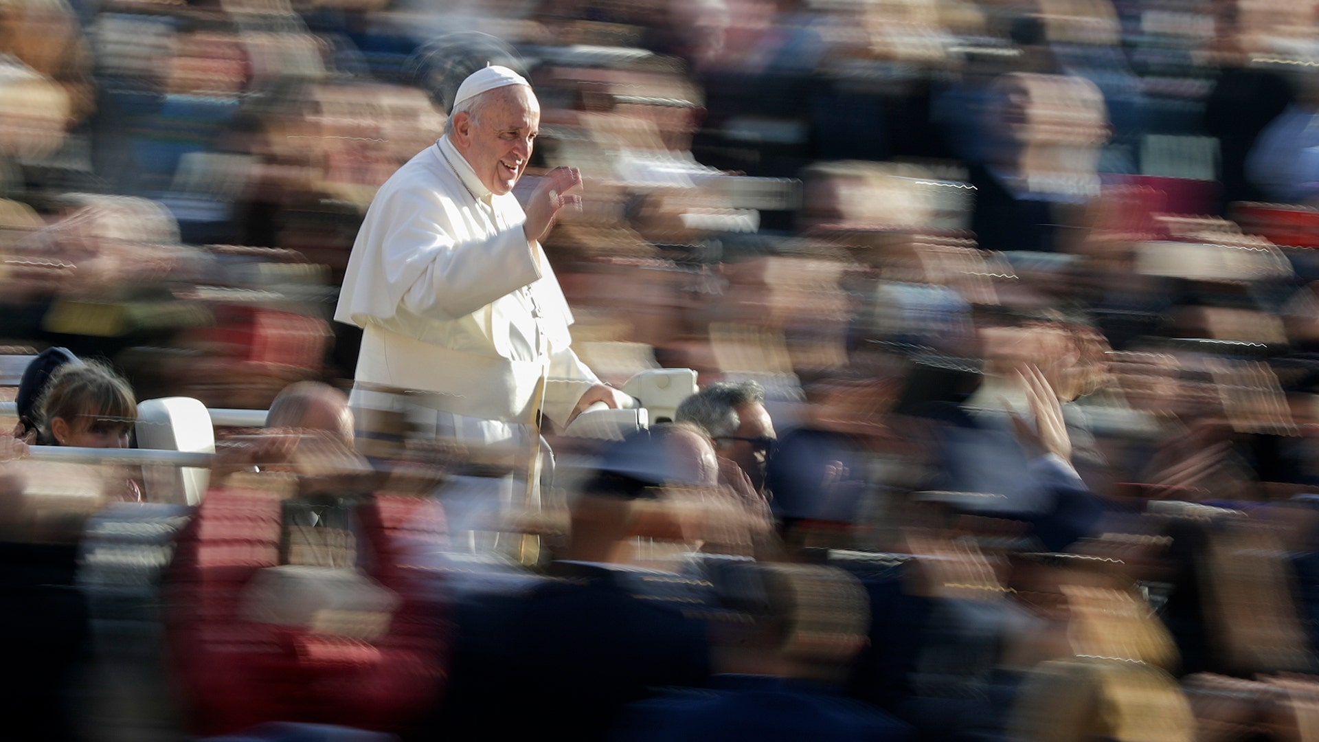 Pope Francis waves to faithful as he arrives for his weekly general audience in St. Peter's Square, at the Vatican, Nov. 27, 2019.