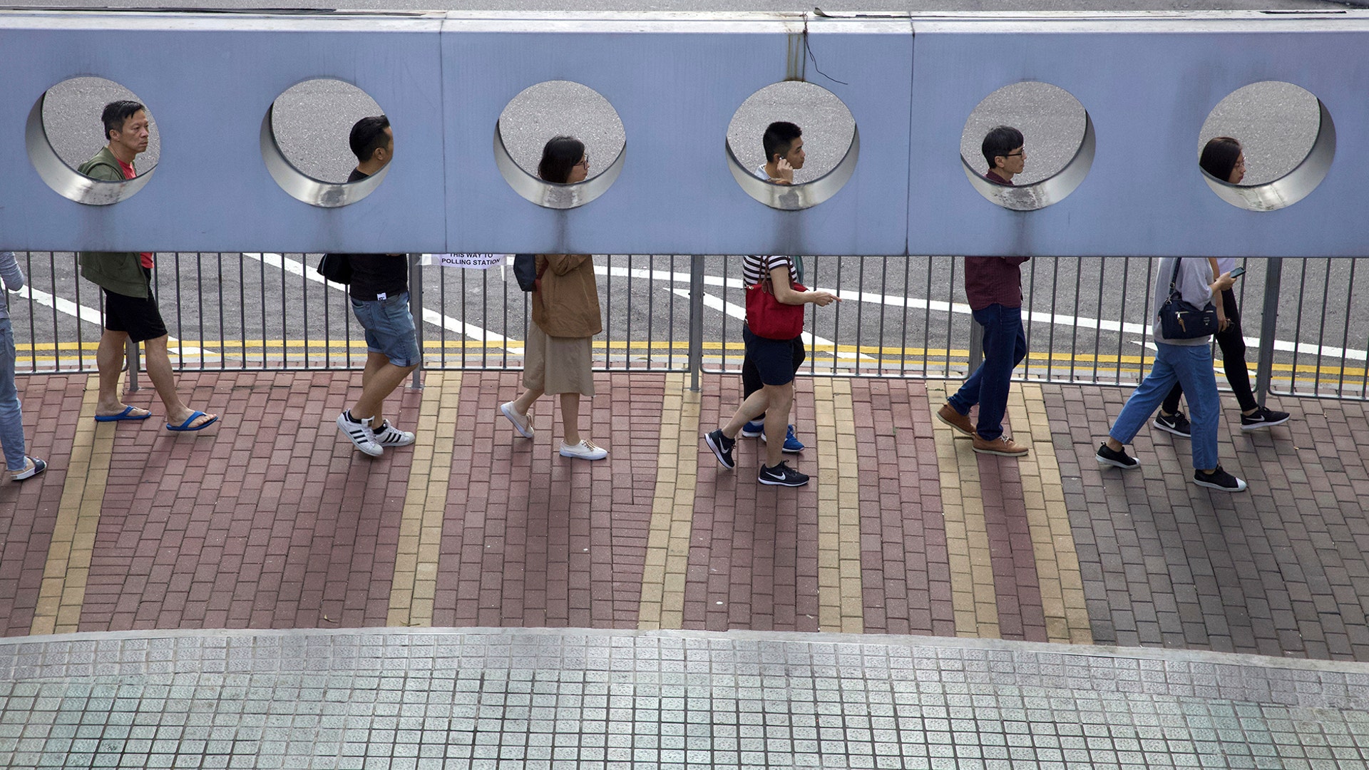 People line up to vote outside of a polling place in Hong Kong, Nov. 24, 2019.