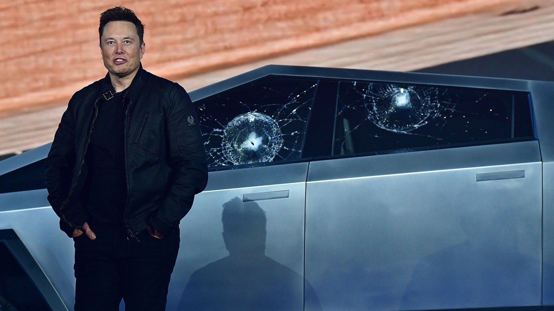 Tesla co-founder and CEO Elon Musk stands in front of the shattered windows of the newly unveiled all-electric battery-powered Tesla's Cybertruck at Tesla Design Center in Hawthorne, California, Nov. 21, 2019. 