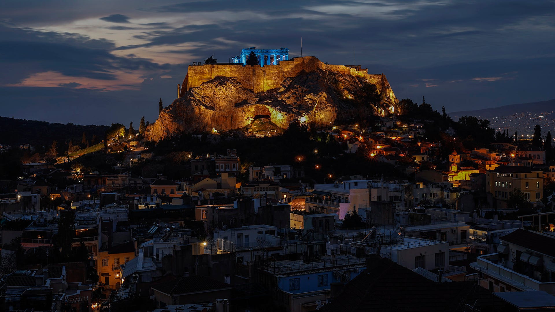 The ancient Parthenon temple atop the Acropolis is lit in blue for UNICEF's World Children's Day celebrations in Athens, Nov. 19, 2019. 