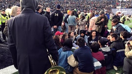 Climate protesters delay Harvard-Yale football game after staging sit-in on field