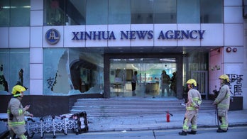 Hong Kong protesters met with tear gas after attacking Chinese news agency offices