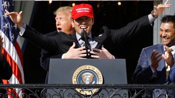 Trump hugs Washington Nationals' Kurt Suzuki, wearing 'MAGA' hat during White House visit