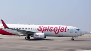 Cracked airplane window covered in clear tape, photo shows