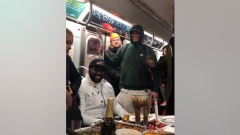 Passengers have full Thanksgiving meal on crowded subway train, video shows
