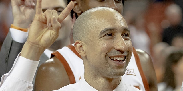 Texas coach Shaka Smart smiles and holds up the "Hook 'em Horns" sign following Texas' 69-45 win over Northern Colorado in an NCAA college basketball game Tuesday, Nov. 5, 2019, in Austin, Texas. (Nick Wagner/Austin American-Statesman via AP)