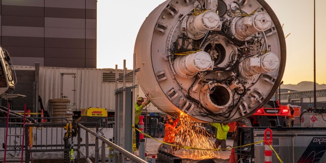 Workers cut the storage rack from the base of the boring head as the Boring company prepares to lower the drill head for the People Mover Tunnels that connect the convention halls as part of the LVCCD Phase 2 construction in the Red lot East of the South Hall at the Las Vegas Convention center on Monday, Oct. 28, 2019.