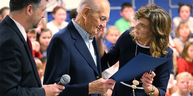 World War II veteran James Wallace Yarbrough, center, was presented an honorary diploma by school principal Lisa Thompson, right, and Hanover school superintendent Dr. Michael Gill, left. (Dean Hoffmeyer/Richmond Times-Dispatch via AP)