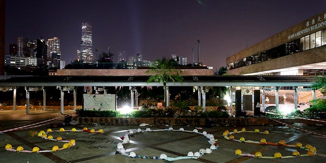 Protesters use clothes and helmets to form "SOS" at Hong Kong Polytechnic University on Thursday.