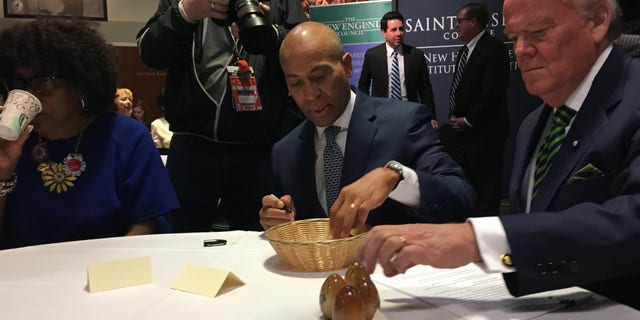 Democratic presidential candidate and former Massachusetts Gov. Deval Patrick signs the famed wooden eggs before headlining 'Politics and Eggs' at the New Hampshire Institute of Politics in Manchester, NH on Nov. 25, 2019