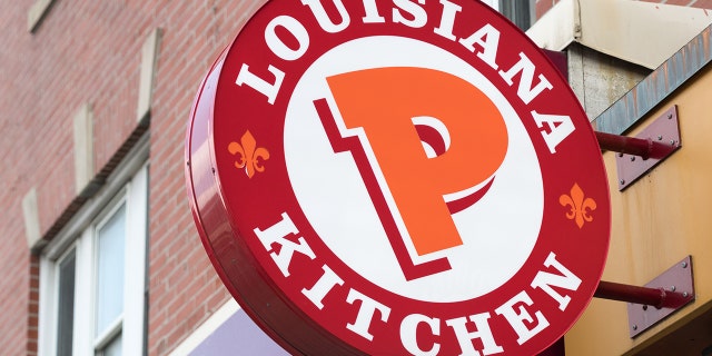 Popeyes Lousiana Kitchen sing or logo outside a restaurant wall. (Photo by Roberto Machado Noa/LightRocket via Getty Images)