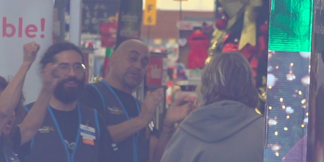 Walmart employees welcome customers with cheers and applause. Customers and employees were allowed back inside the El Paso location more than three months after a gunman killed 22 people at that location. (Fox News/Charles Watson)