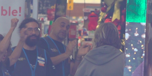 Walmart employees welcome customers with cheers and applause. Customers and employees were allowed back inside the El Paso location more than three months after a gunman killed 22 people at that location. (Fox News/Charles Watson)