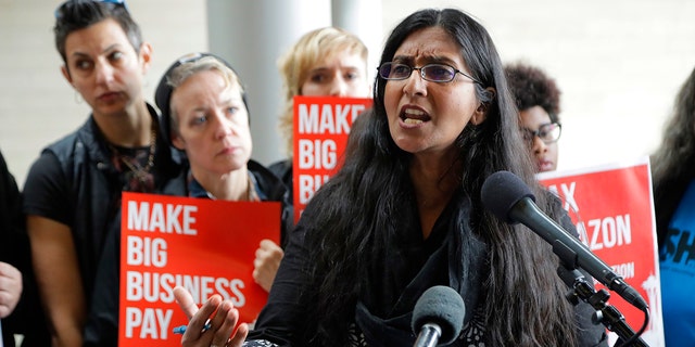 In this June 12, 2018, file photo, Seattle City Councilmember Kshama Sawant speaks at City Hall in Seattle. Seven of the nine Seattle City Council seats are up for grabs in next month's election, where retail giant Amazon has made unprecedented donations totaling $1.5 million to a political action committee that's supporting a slate of candidates perceived to be friendlier to business. Among the company's top targets is Sawant, a fierce critic of Amazon, who is running against Egan Orion in the District 3 race. (AP Photo/Ted S. Warren, File)