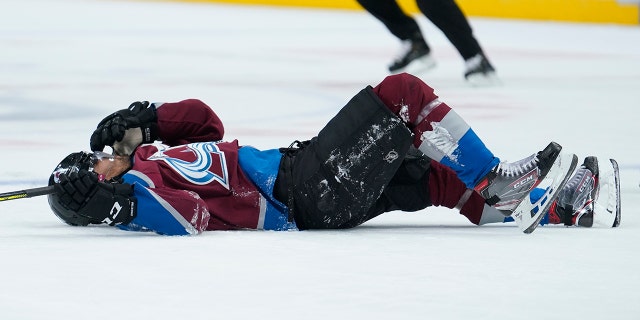 Colorado Avalanche left wing Pierre-Edouard Bellemare lies on the ice after being hit by Columbus Blue Jackets left wing Nick Foligno during the second period of an NHL hockey game, Saturday, Nov. 9, 2019, in Denver. (AP Photo/Jack Dempsey)
