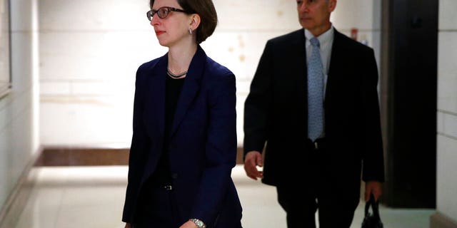 Deputy Assistant Secretary of Defense Laura Cooper, left, arrives to review her testimony as part of the House impeachment inquiry into President Donald Trump, Wednesday, Oct. 30, 2019, on Capitol Hill in Washington. (AP Photo/Patrick Semansky)